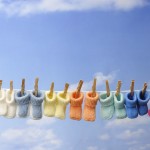 Every Day Sacred - several colorful baby booties on clothes line