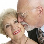 Every Day Sacred - closeup of a loving senior man gives his beautiful wife a kiss on the cheek