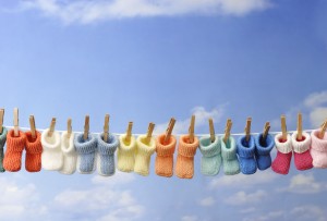 Every Day Sacred - several colorful baby booties on clothes line